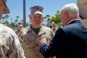 Secretary of Defense Robert M. Gates presents the Purple Heart to Marine Gunnery Sgt. David Rohde at Balboa Naval Hospital in San Diego